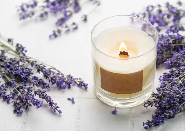 Aroma Candle. Lavender candle on a white tile background. Lavender spa.