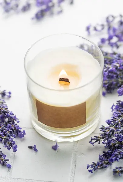 Aroma Candle. Lavender candle on a white tile background. Lavender spa.