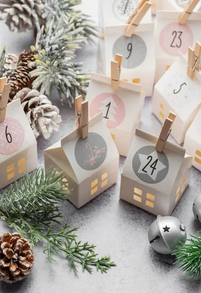 Preparation of christmas advent calendar. Advent calendar, Christmas gifts and decorations on a concrete background.