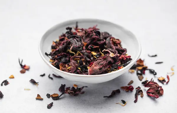 Bowl with Dry Hibiscus Tea on a table