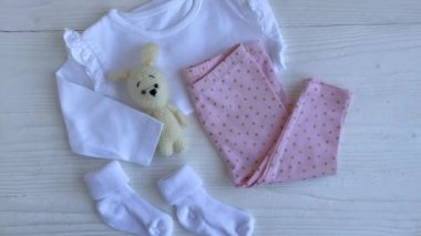 Bebek kıyafetleri, pantolonlar, çoraplar ve örgü oyuncaklar. Bebek kıyafetleri ve aksesuarlar. Düz yatış, üst görünüm