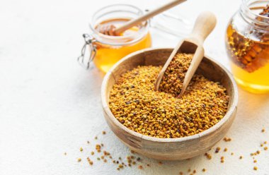 Çiğ organik arı poleni ve kavanozlarda bal.