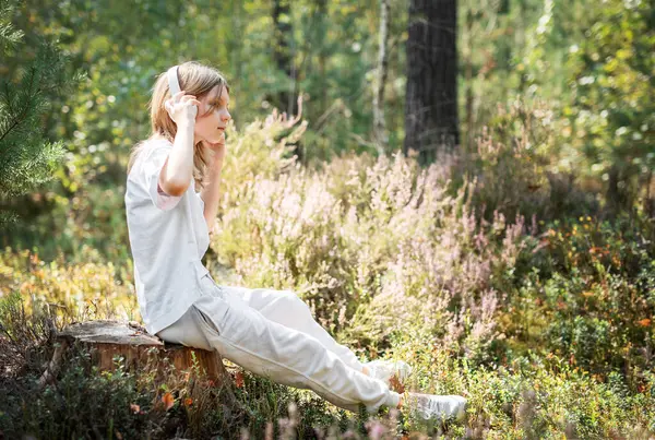 Stock image A teenage girl who breathes fresh air and relieves stress in the forest. Dreamy peaceful relaxed girl breathing the fresh air of nature.