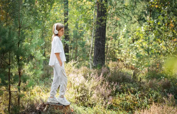 stock image A teenage girl who breathes fresh air and relieves stress in the forest. Dreamy peaceful relaxed girl breathing the fresh air of nature.