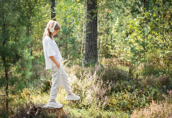 stock image A teenage girl who breathes fresh air and relieves stress in the forest. Dreamy peaceful relaxed girl breathing the fresh air of nature.