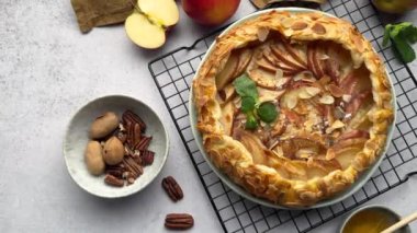 Lezzetli elmalı turta, taze malzemelerle çevrili bir tezgahta duruyor.