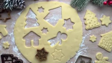 Baker hamurdan noel kurabiyesi kesicileri çıkarıyor