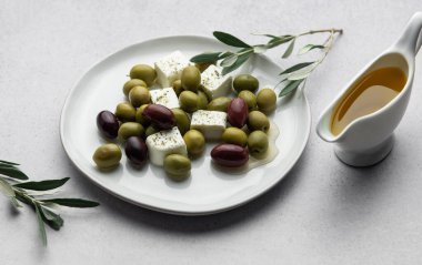 İçinde zeytin, peynir, zeytin yağı ve taze bitkiler bulunan lezzetli ve sağlıklı Yunan salatası hafif bir yemek veya aperatif için mükemmeldir.