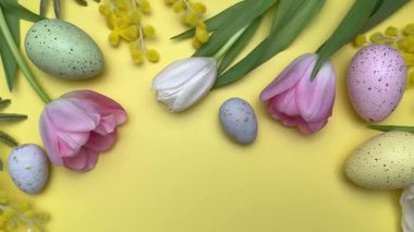 Paskalya yumurtaları ve laleler renkli bir çerçeve oluşturuyor.