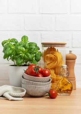 Lezzetli bir İtalyan makarna yemeği için malzemeler ahşap bir tezgahta kullanıma hazır.