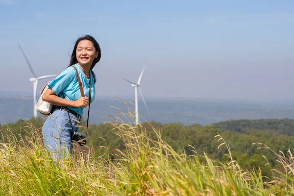 旅行者の女の子は山と風力タービン テン電気風力タービンタイの美しい景色を振り返ってみる — ストック写真