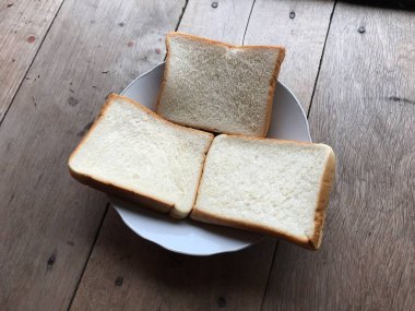 Bread on wooden background. Rustic rye. Fresh loaf of rustic traditional bread on wooden texture background. Bakery with crusty loaves. Design element for bakery product label, design, and etc