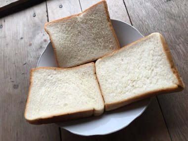 Bread on wooden background. Rustic rye. Fresh loaf of rustic traditional bread on wooden texture background. Bakery with crusty loaves. Design element for bakery product label, design, and etc