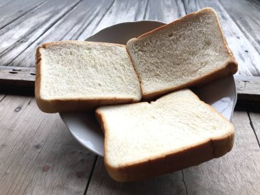 Bread on wooden background. Rustic rye. Fresh loaf of rustic traditional bread on wooden texture background. Bakery with crusty loaves. Design element for bakery product label, design, and etc