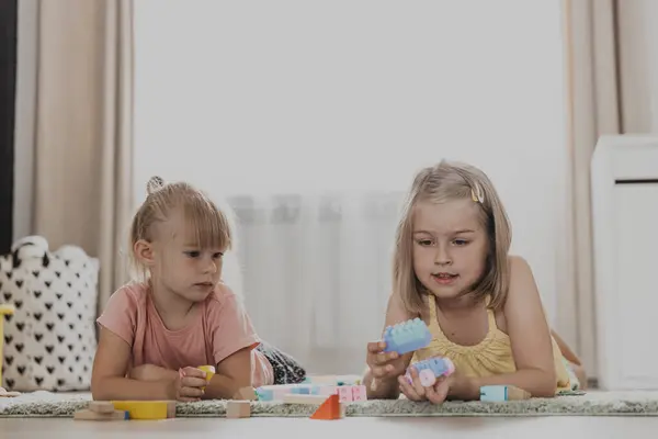 Barn Leker Med Färgglada Leksaker Barn Som Sitter Mattan Hemma Stockbild