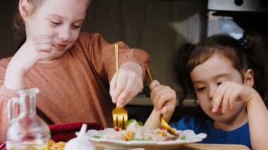 Kızlar ördek ve cevizle Satsivi 'nin tadına bakıyorlar. Geleneksel Gürcü yemekleri.