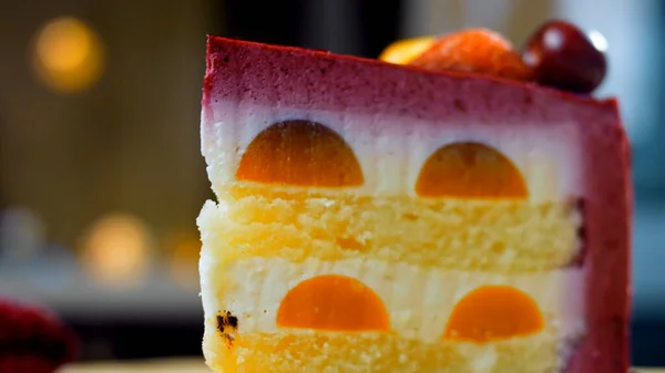 stock image A slice of cake with strawberries and white and red cherries. The cake has a special dome structure. Macro and slider shooting. In the background is a retro atmosphere.