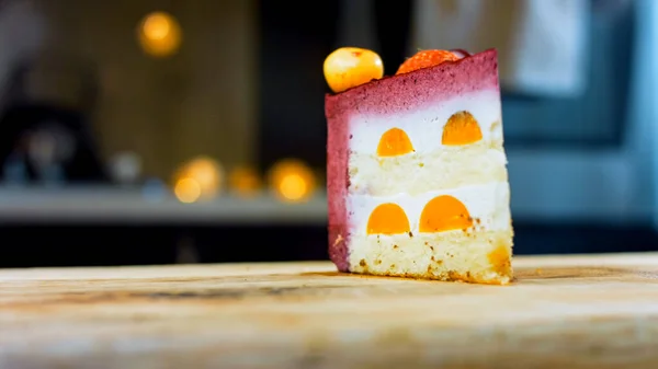 stock image A slice of cake with strawberries and white and red cherries. The cake has a special dome structure. Macro and slider shooting. In the background is a retro atmosphere.