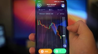 Caucasian male making a payment with bitcoins cryptocurrency using his smartphone. Custom application interface design. Light rays effect.