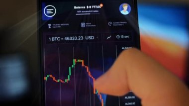 Caucasian male making a payment with bitcoins cryptocurrency using his smartphone. Custom application interface design. Light rays effect.