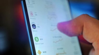 Caucasian male making a payment with bitcoins cryptocurrency using his smartphone. Custom application interface design. Light rays effect.