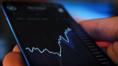 Caucasian male making a payment with bitcoins cryptocurrency using his smartphone. Custom application interface design. Light rays effect.