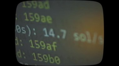 Cryptocurrency mining on a computer screen. The algorithm of the computer program on the monitor. Execution of the program code for the mining program. Pop-up lines of a computer program.