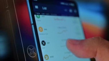 Caucasian male making a payment with bitcoins cryptocurrency using his smartphone. Custom application interface design. 4K UHD RAW edited footage