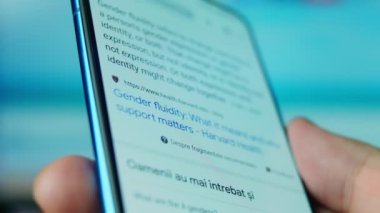 Looking at the smartphone, questions about gender fluid.