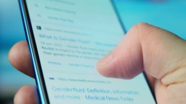 Looking at the smartphone, questions about gender fluid.