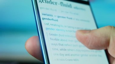 Looking at the smartphone, questions about gender fluid.