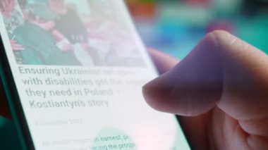 Looking at the smartphone, I read information about disability.