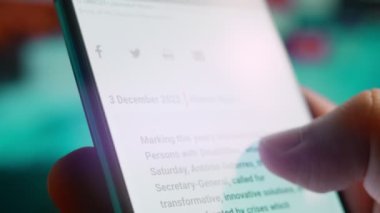 Looking at the smartphone, I read information about disability.