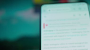 Looking at the smartphone, I read information about androgynous.