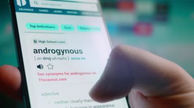 Looking at the smartphone, I read information about androgynous.