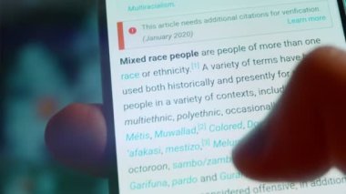 Looking at the smartphone, I read information about multiracial.