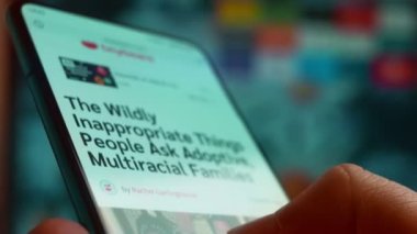 Looking at the smartphone, I read information about multiracial.