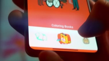 Looking at the smartphone, application about the gospel.