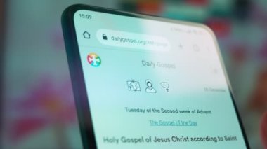 Looking at the smartphone, I read information about the gospel.
