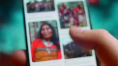 Smartphone in hand, macro view of the indigenous question.