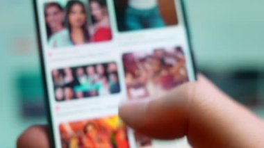 Smartphone in hand, macro view of the bollywood question