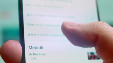 Smartphone in hand, macro view of the bollywood question