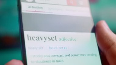 Smartphone in hand, macro view of the heavyset question.