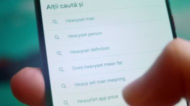 Smartphone in hand, macro view of the heavyset question.