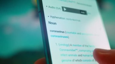 Smartphone in hand, looking for information about the coronavirus.