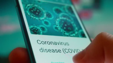 Smartphone in hand, looking for information about the coronavirus.