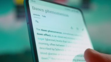 Smartphone in hand, looking for information about down syndrome.