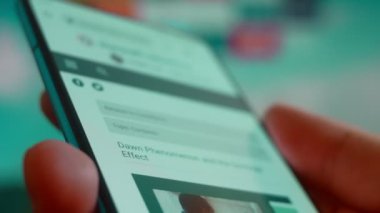 Smartphone in hand, looking for information about down syndrome.