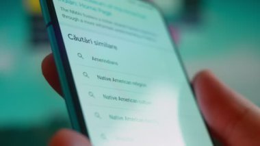 Smartphone in hand, looking for information about Native Americans.