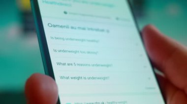Smartphone in hand, looking for information about overweight.